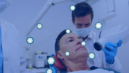 Network of digital icons over caucasian male dentist examining male patient's teeth at the clinic - Powered by Adobe