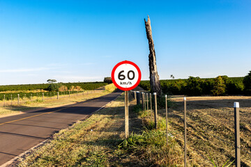 Traffic signpost, which indicates the maximum speed allowed at the location, on a road in Brazil