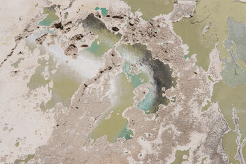 Damaged wall with holes texture background. Creative backdrop. Old, abandoned building interior fragment. Weathered and cracked bricks with concrete, peeled off paint and moss. Close up, copy space