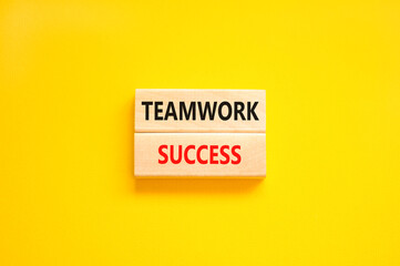 Teamwork success symbol. Concept words Teamwork success on wooden blocks on a beautiful yellow table yellow background. Business and teamwork success concept. Copy space.