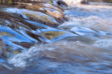 water flowing into the river over the rocks
