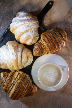 Chocolate Croissant And A Cup Of Coffee On A Blackboard Top View