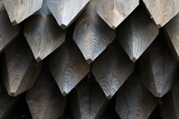 A stack of sharp pointed wooden piles .