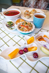 chicken soup with salad and bread on a bell tablecloth