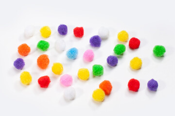 fluffy round colorful balls isolated on white surface