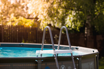 Swimming pool with metal frame for home and garden. Frame swimming pool in the yard. Solar...