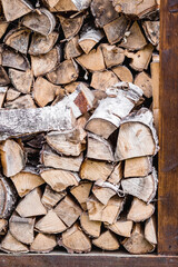 Fototapeta premium Heating season without gas. It's warm in the house. A stack of firewood for heating the house. The trees were cut down and split into firewood for use as fuel for fireplaces and stoves.