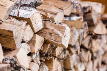 Heating season without gas. It's warm in the house. A stack of firewood for heating the house. The trees were cut down and split into firewood for use as fuel for fireplaces and stoves.