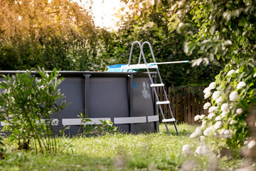 Swimming pool with metal frame for home and garden. Frame swimming pool in the yard. Solar...