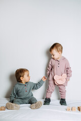 Baby fashion. Unisex clothes for babies. Two Cute baby girls or boys in cotton set