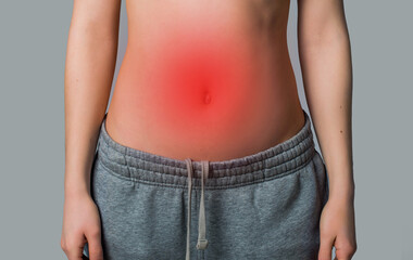 woman's stomach with redness on gray background. stomach problems concept - obrazy, fototapety, plakaty
