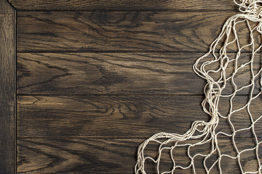 Fishing net on old oak board background with copy space