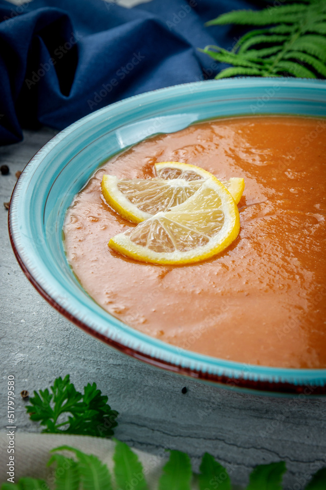 Poster  Lentil cream soup with lemon slices in a plate on a light table - Posters
