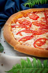 Margarita pizza on a shovel. Freshly baked with parmesan, tomato and sauce