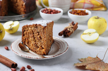 Homemade apple pie with cinnamon, raisins and peanuts, sprinkled with powdered sugar