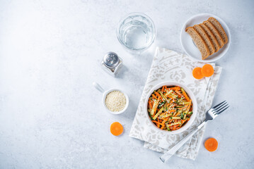 Asian cucumber carrot salad with sesame seeds in a bowl