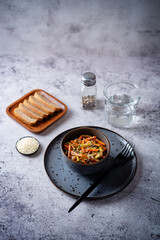 Asian cucumber carrot salad with sesame seeds in a bowl