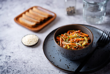 Asian cucumber carrot salad with sesame seeds in a bowl