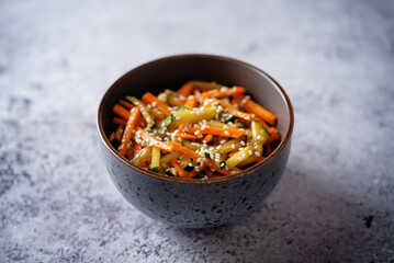 Asian cucumber carrot salad with sesame seeds in a bowl