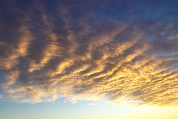 Naklejka na ściany i meble Colorful stratocumulus clouds, at sunset