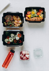 daily ration of food in disposable dishes on a white background top view. food for breakfast lunch and dinner plus dessert. healthy food delivery