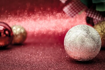 christmas background with red sparkles decorated with red and gold balls