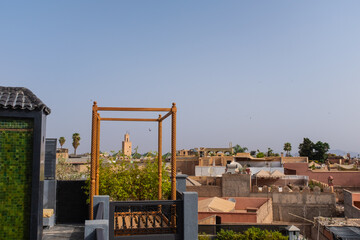 Marrakesh skyline with tower Mosque landmarks from a rooftop on a blue sky