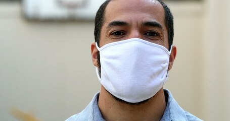 Man putting covid face mask prevention