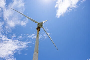 Wind turbine over the blue sky