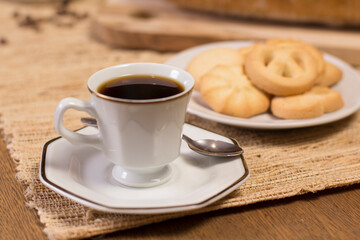 table with coffee cup and butter cookies.