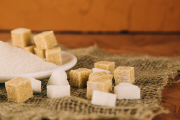 Different sugar on dark table. Sugar is unhealthy nutrition and leads to obesity, diabetes