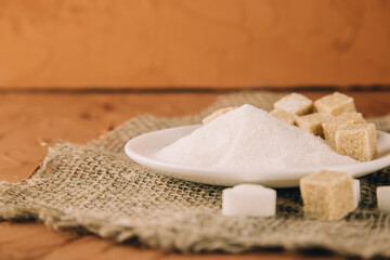 Different sugar on dark table. Sugar is unhealthy nutrition and leads to obesity, diabetes