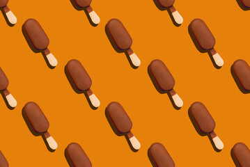 seamless pattern of a chocolade glazed eskimo on an orange background