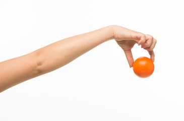 hand holding orange sponge ball isolated