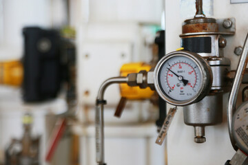 Pressure gauge using measure the pressure in production process. Worker or Operator monitoring oil and gas process by the gauge for routine record and analysis oil and gas production process.