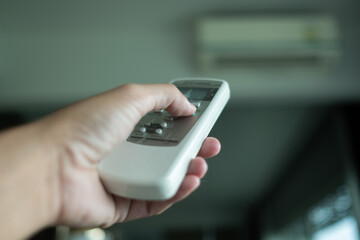 remote control air condition on hand, save power concept
