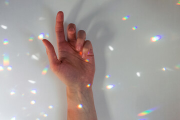 Woman's hand and prism light reflection