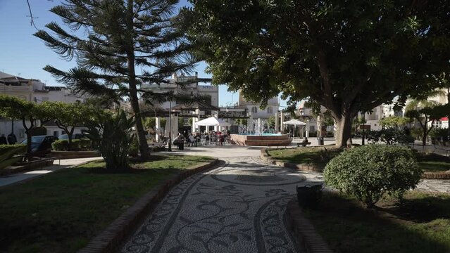 Cafe, fountain and trees in Plaza Cantarero in Nerja Town, Nerja, Malaga