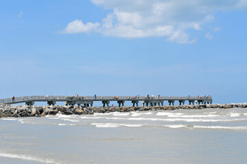Concrete walking and fishing pier at Jetty State Park in the port at Cape Canaveral near Cocoa Beach, Florida. 