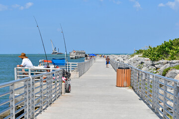 Concrete walking and fishing pier at Jetty State Park in the port at Cape Canaveral near Cocoa Beach, Florida. 