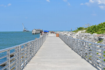 Concrete walking and fishing pier at Jetty State Park in the port at Cape Canaveral near Cocoa...