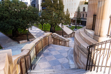 Stairs beside the Shrine of Remembrance in Anzac Square Brisbane leading down to the memorial park and statues.