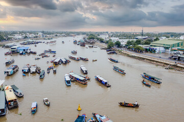 Bustling scene with boats full of agricultural products moored at Cai Rang floating market to trade