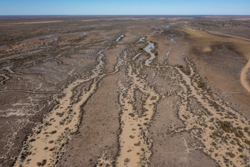 Flood waters flowing down Cooper creek in western Queensland heading towards Lake Eyre.