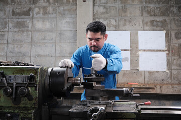 One professional Asian male industry engineer worker works in a safety uniform with metalwork...
