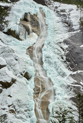 Fototapeta na wymiar Icy Wall and Waterfall. Shannon Falls spray and ice in winter. Located near Squamish north of Vancouver. British Columbia, Canada.
