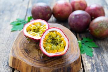 Passion fruit ( Maracuya ) with Passion fruit cut in half slice on wooden table background .