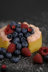 Cake with cream covered with juicy berries.
