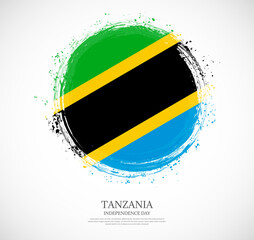 Creative circular grungy shape brush stroke flag of Tanzania on a solid background