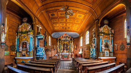 Fototapeta na wymiar The interior of the wooden church Blessed Virgin Mary of the Assumption from 1743 in Czarlejno, Greater Poland voivodeship, Poland.